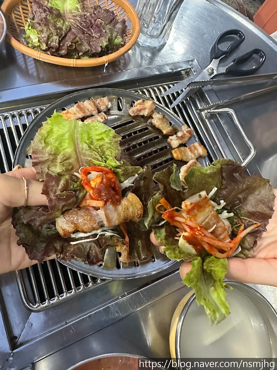 A lettuce wrap with samgyeopsal and kimchi