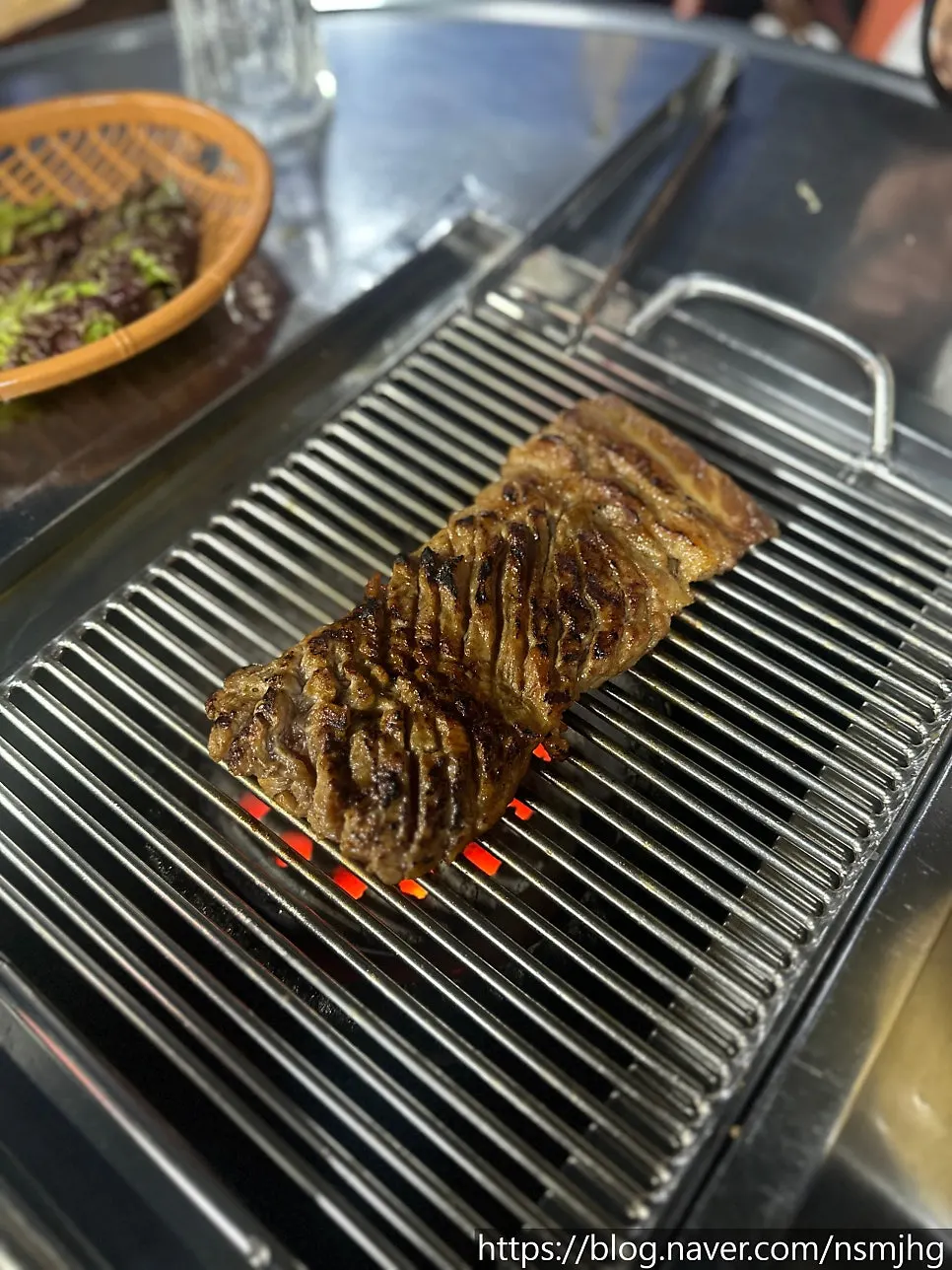 Seasoned pork rib grilling over charcoal