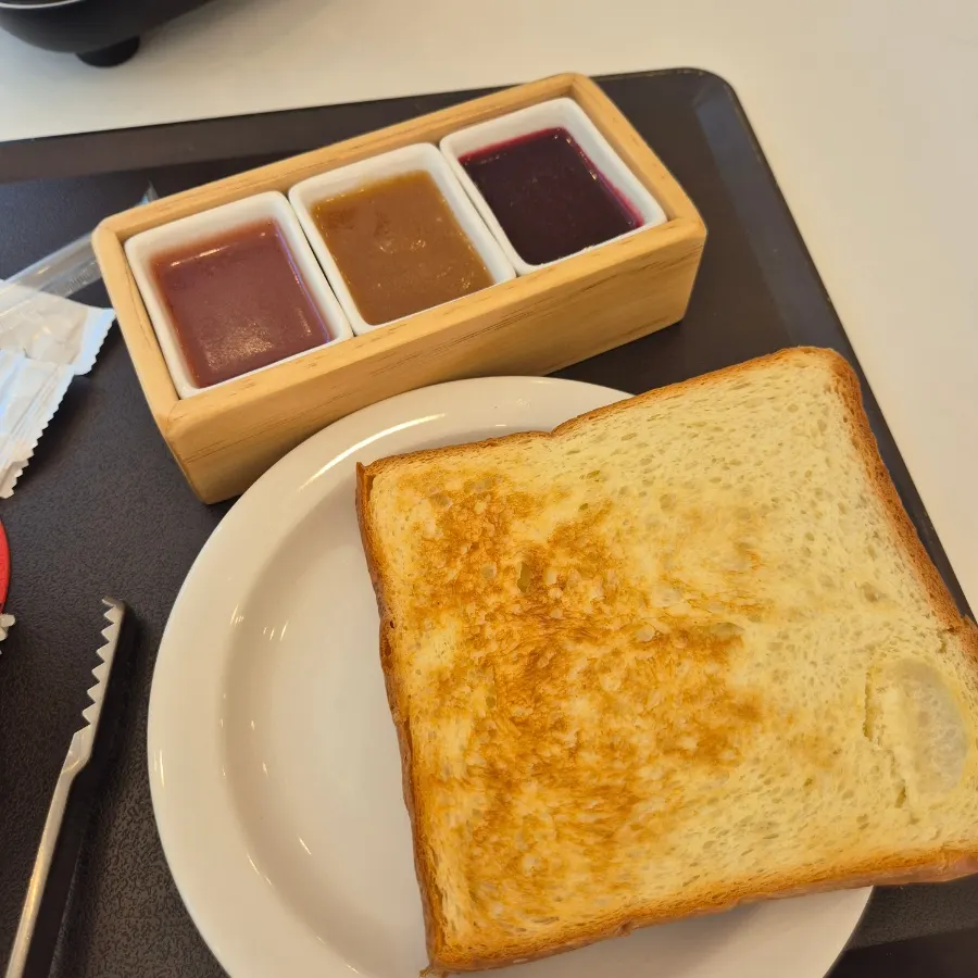 Freshly toasted bread with a plate of jam
