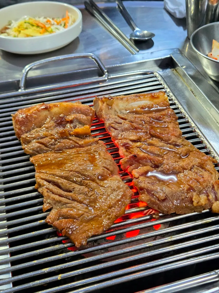 Pork king galbi grilling over charcoal