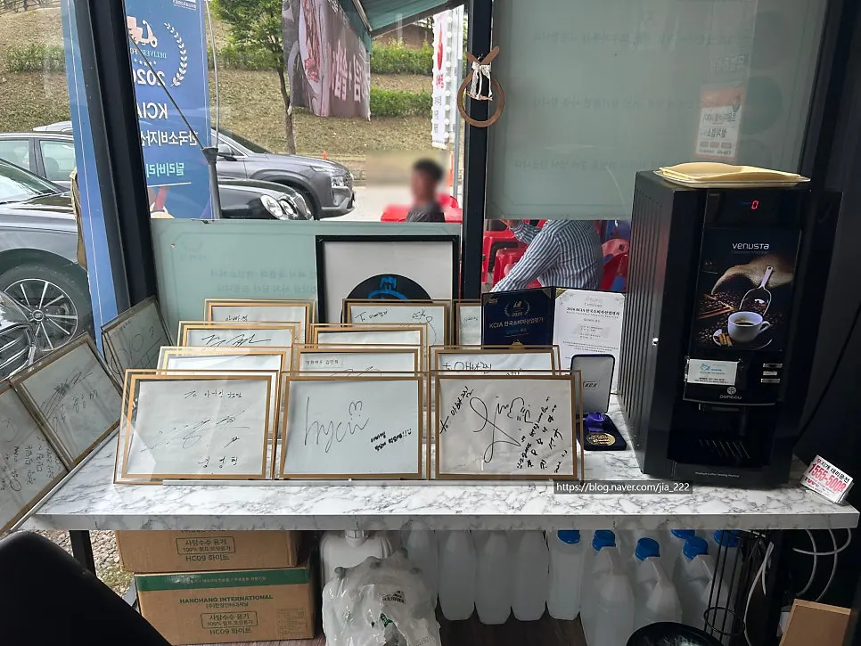 Framed celebrity autographs displayed near the counter