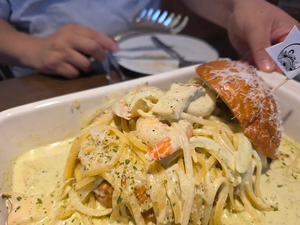 Dipping bread into the pasta sauce