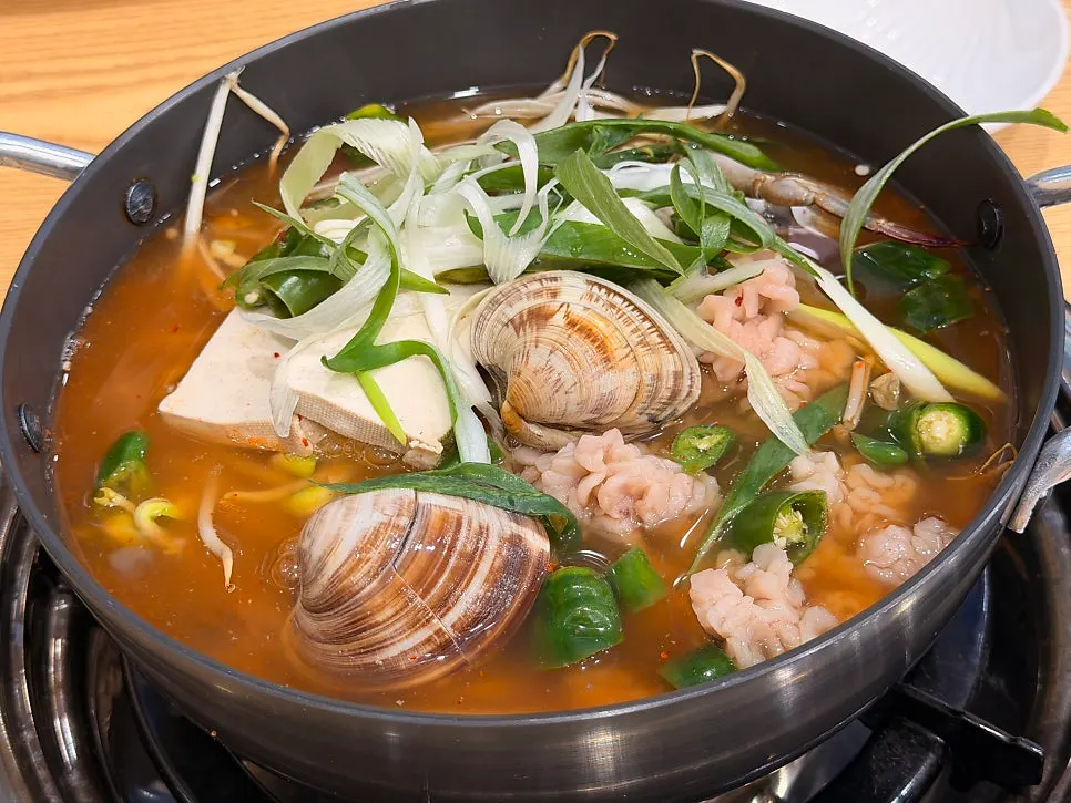 A pot of spicy seafood stew served at the table