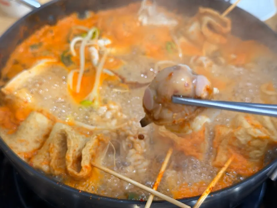 Roe and milt fished out of the spicy seafood stew