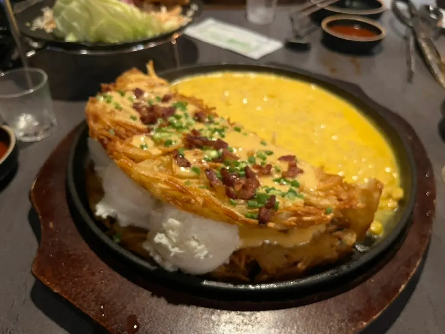 Close-up of cheese-topped potato pancake