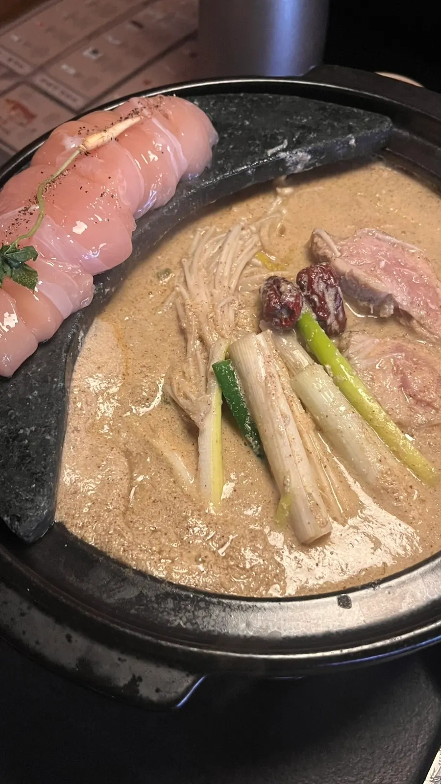 A tender piece of chicken cooked in the hotpot
