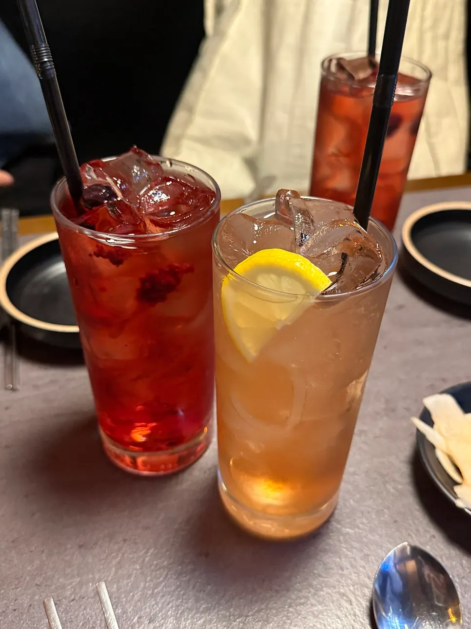 A glass of vivid red bokbunja watermelon highball