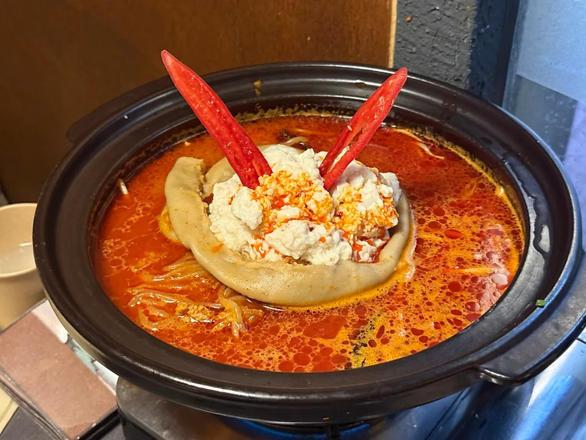 A pot of beef tripe sundubu jeongol topped with soft tofu