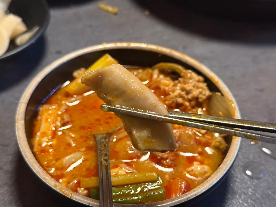 Tripe and udon noodles served in a small bowl