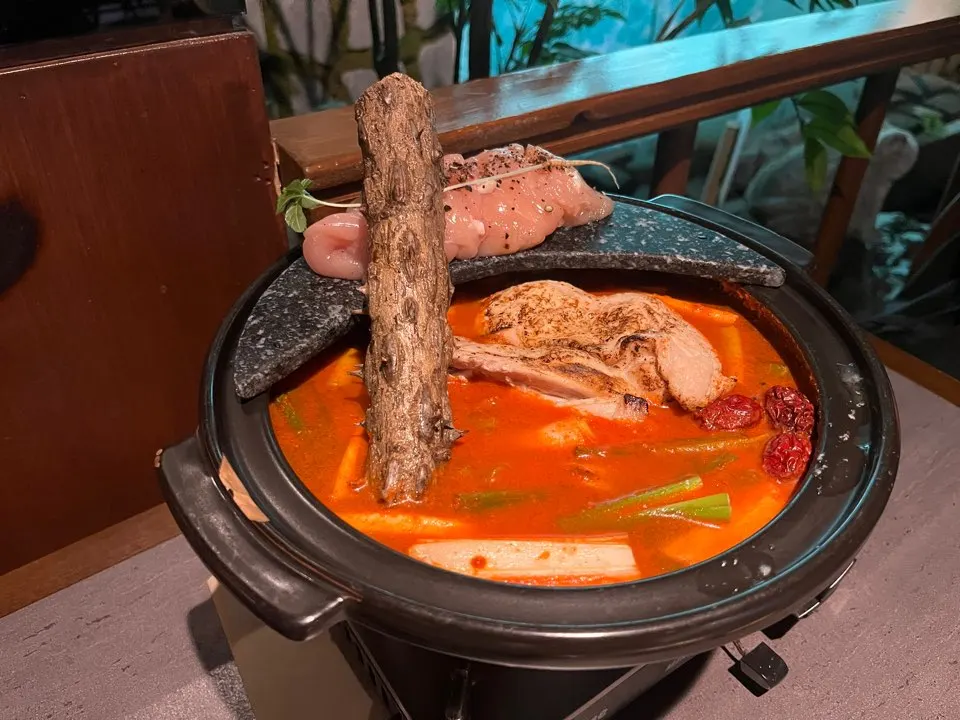 Spicy hangover chicken hot pot in an earthenware pot on the burner