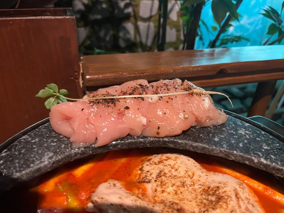 Bubbling red broth of the spicy hangover chicken hot pot