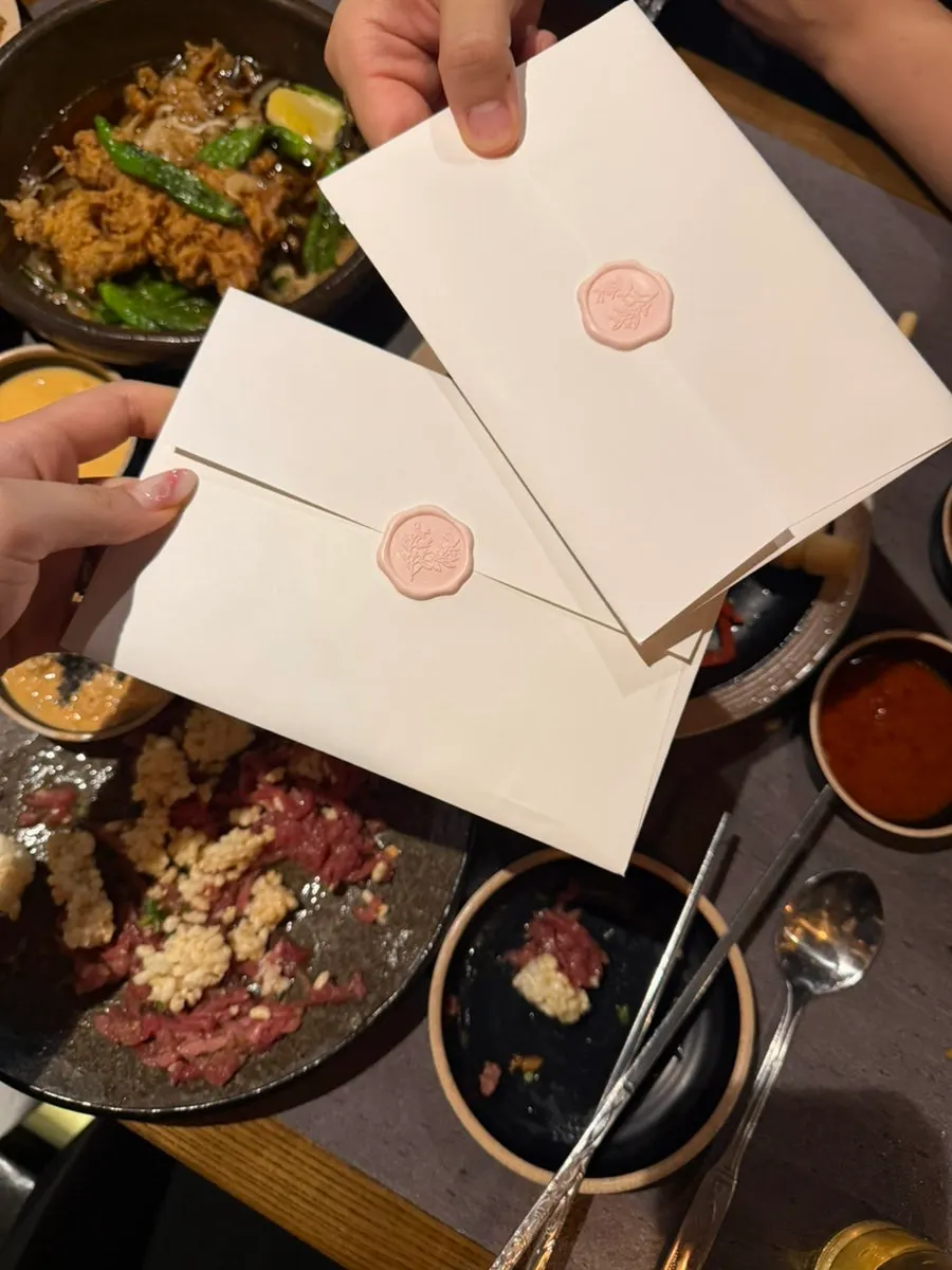 Table spread with side dishes and somaek at the wedding-invite gathering