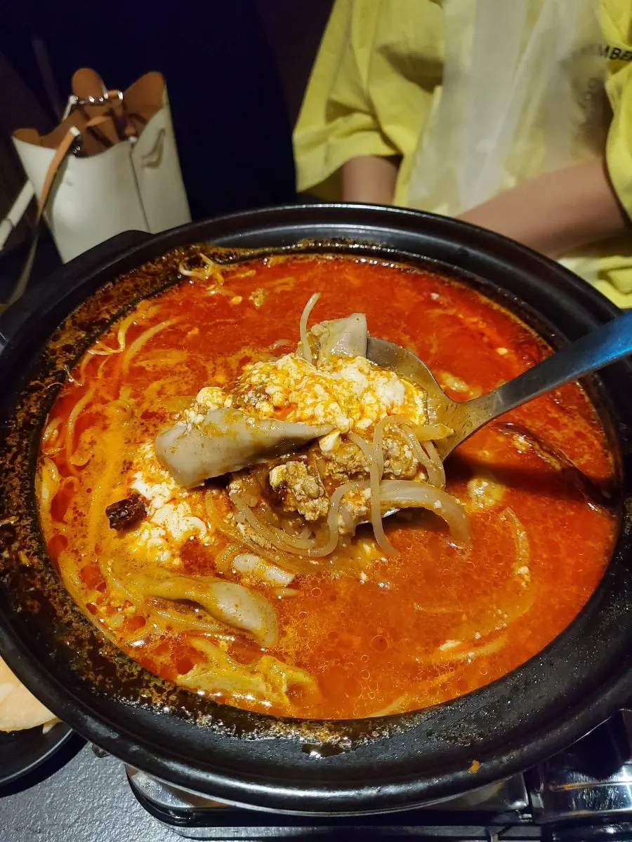 Beef tripe soft tofu stew bubbling on the table
