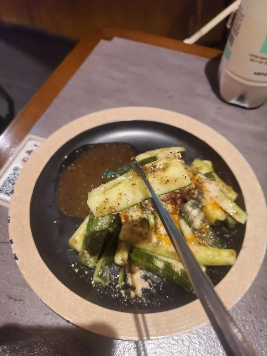Cucumber salad topped with black sesame sauce