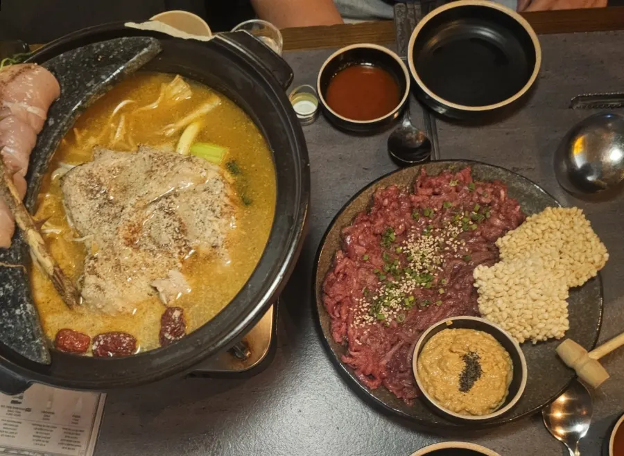 Table spread with perilla chicken hot pot and nurungji monkfish liver hoe