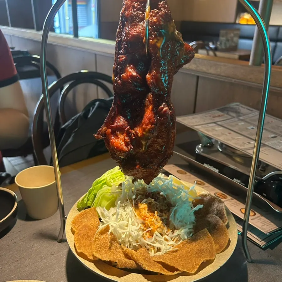 Ari Gyegok's mud duck pancake served whole and hanging
