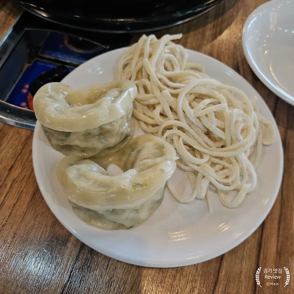 Steamed Gaeseong dumplings served alongside the hot pot