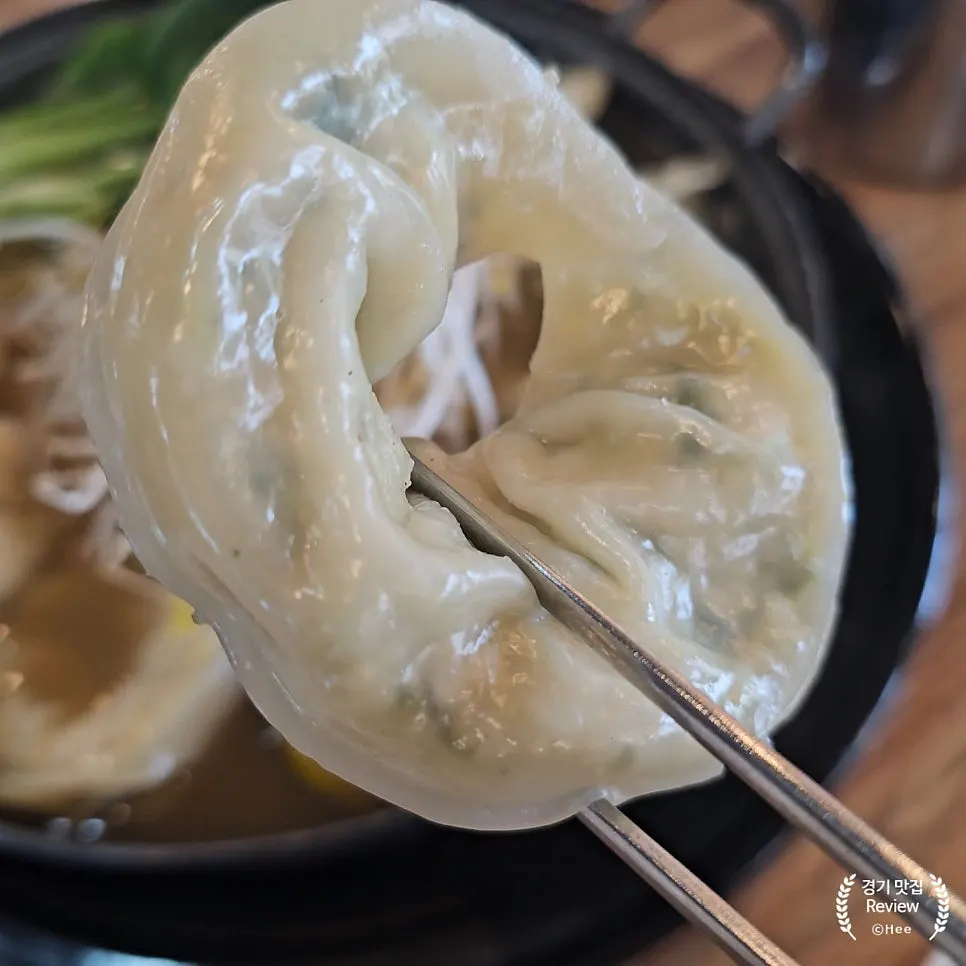 Steamed dumpling dipped in wasabi soy sauce