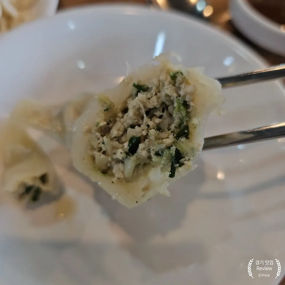 Bitten-into steamed dumpling showing the filling