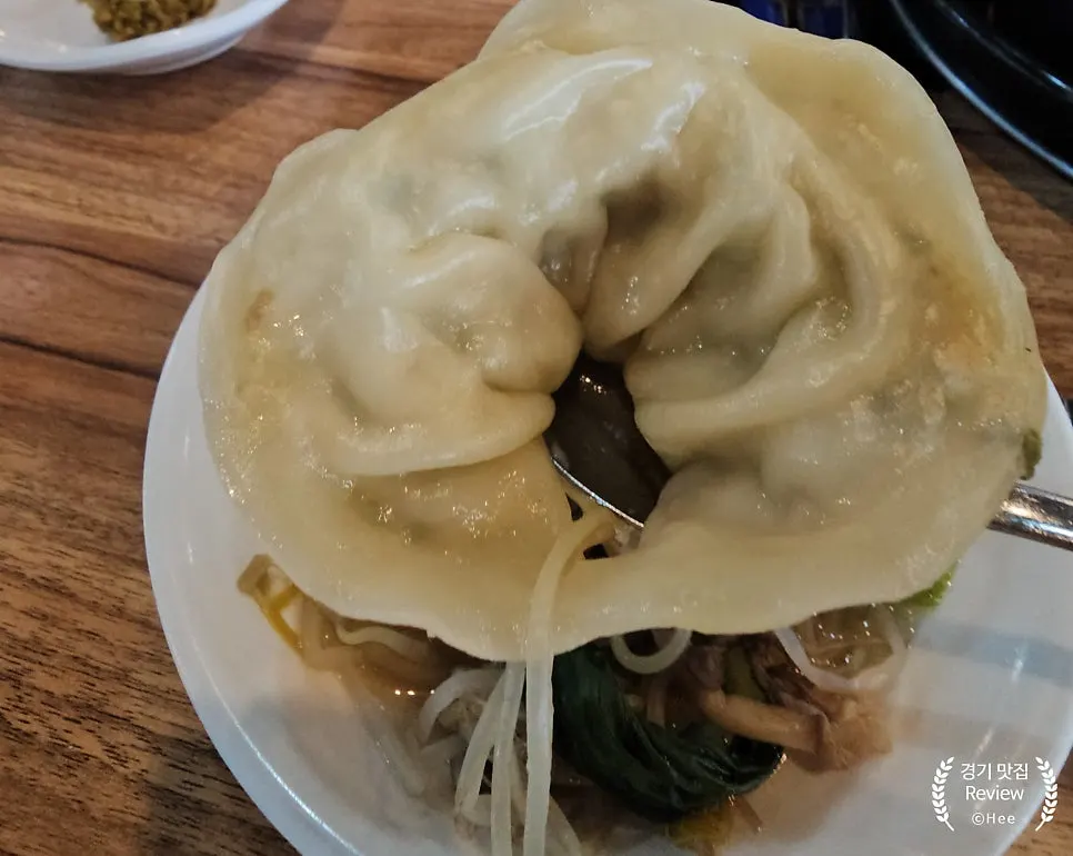 Handmade dumpling scooped up with the broth
