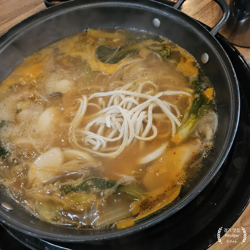 Noodles added and boiled in the hot pot broth