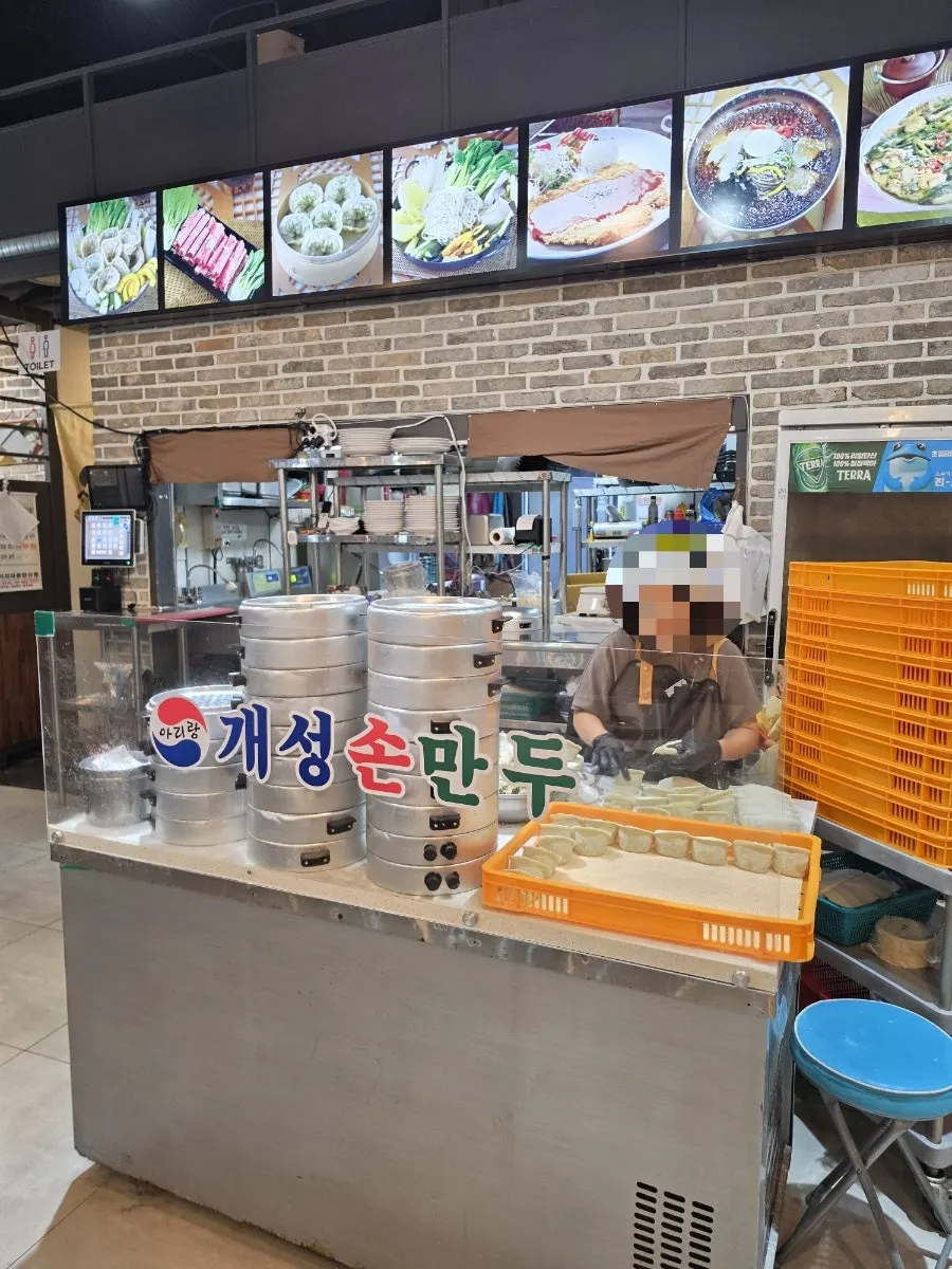 Dumplings being hand-pinched in a corner of the restaurant