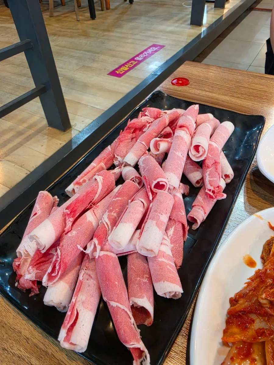 Beef being added to the hot pot