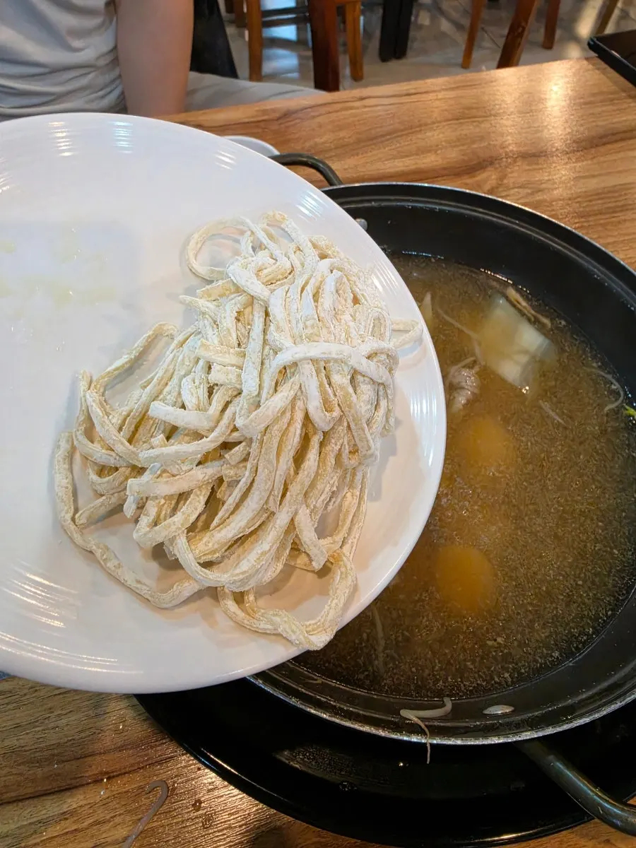 Kalguksu noodles added into the remaining broth