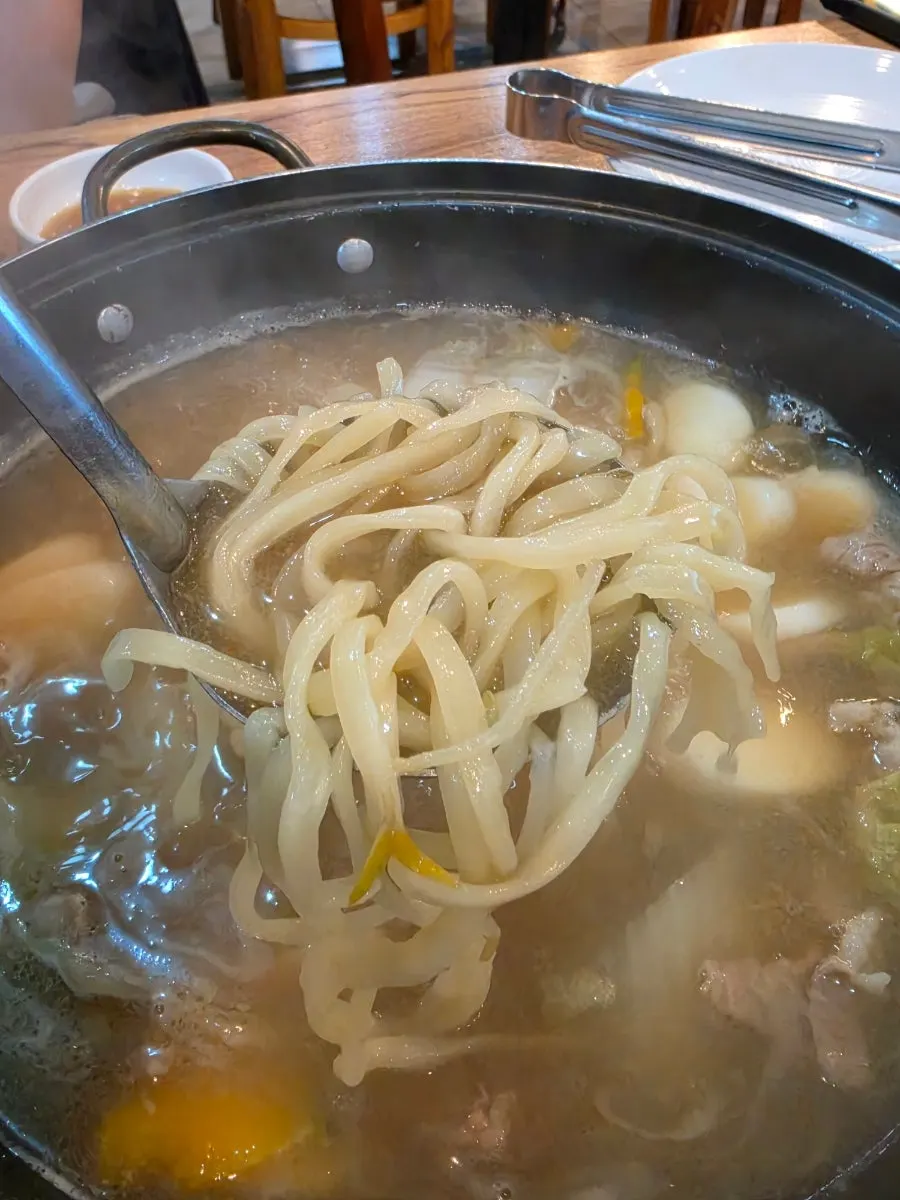 Kimchi placed on top of the kalguksu noodles