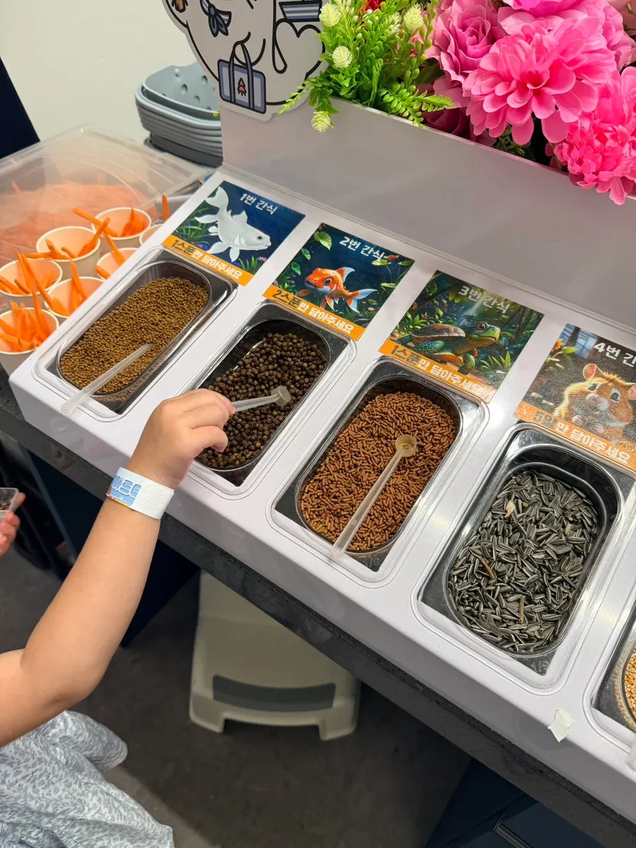 Child scooping snacks into a container