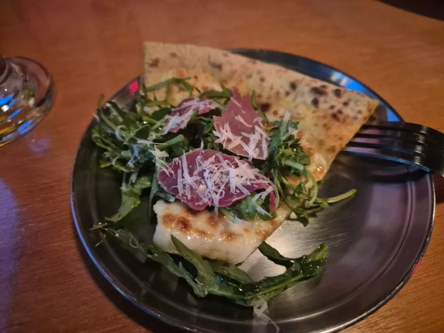 A whole arugula prosciutto pizza