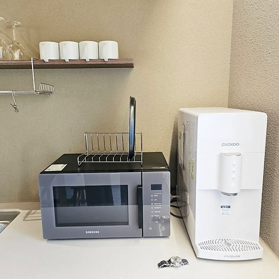 Kitchen with microwave and water purifier
