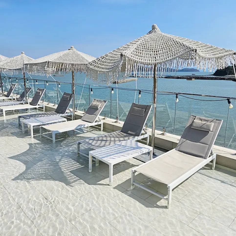 Poolside area with parasols and free sun loungers