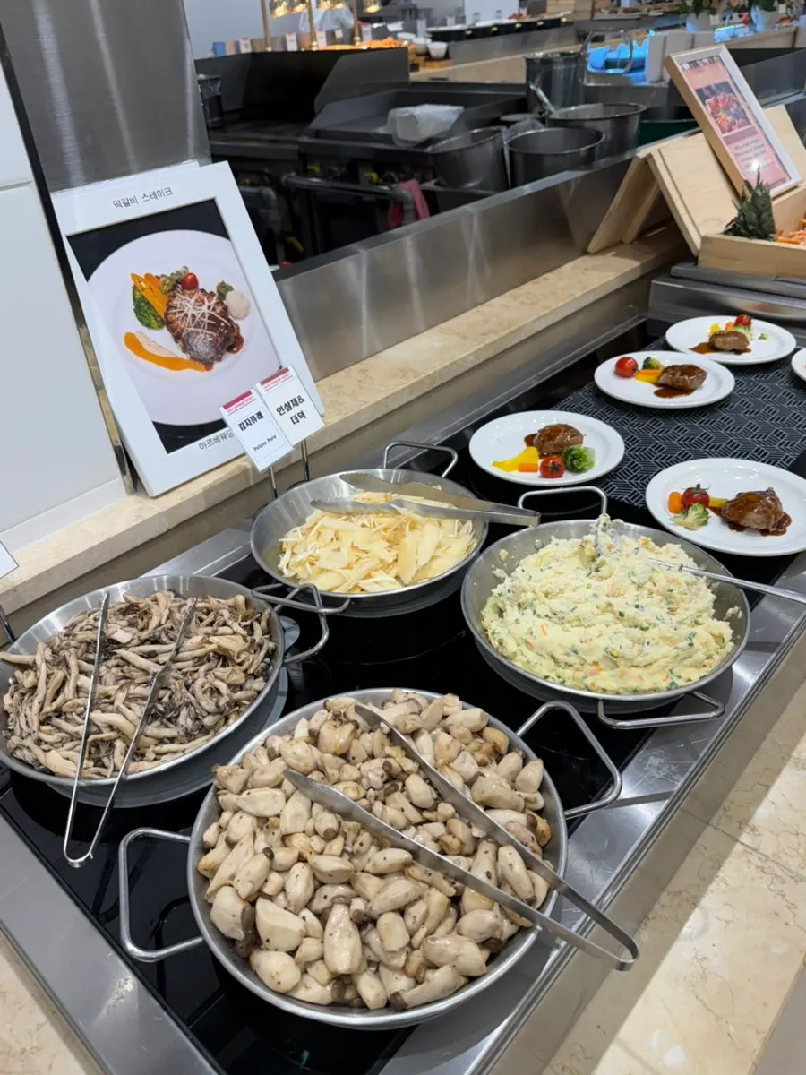 A plate of sashimi and buffet food
