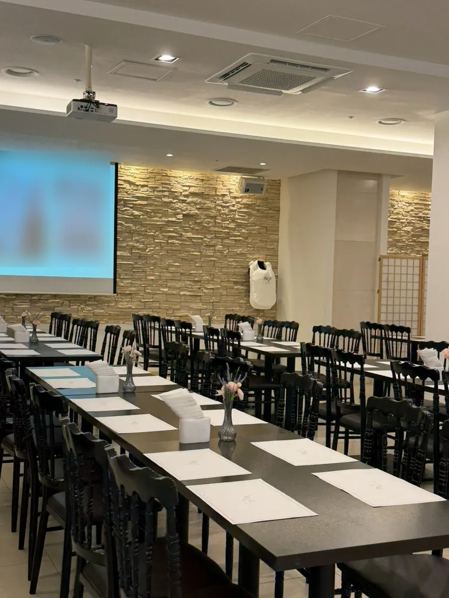 Projector screen showing the live ceremony in the banquet hall
