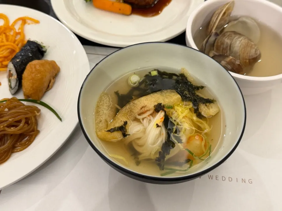 A plate with sashimi, sushi, and Korean dishes