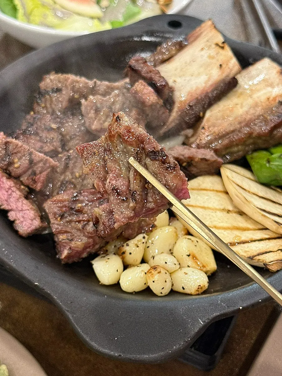 Woo seokgalbi grilled with rib bones, king oyster mushroom, and shishito peppers