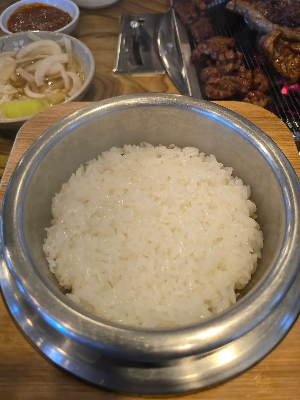 Lid lifted off the steaming hotpot rice