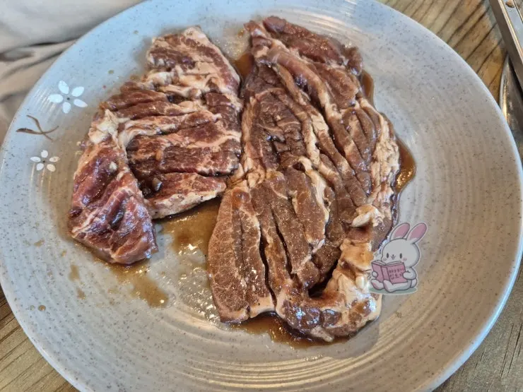 Marinated galbi grilling on the charcoal grate