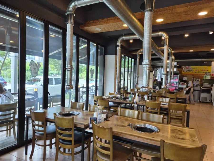 Bright interior tables at Ilpum Chamsut Galbi with floor-to-ceiling windows