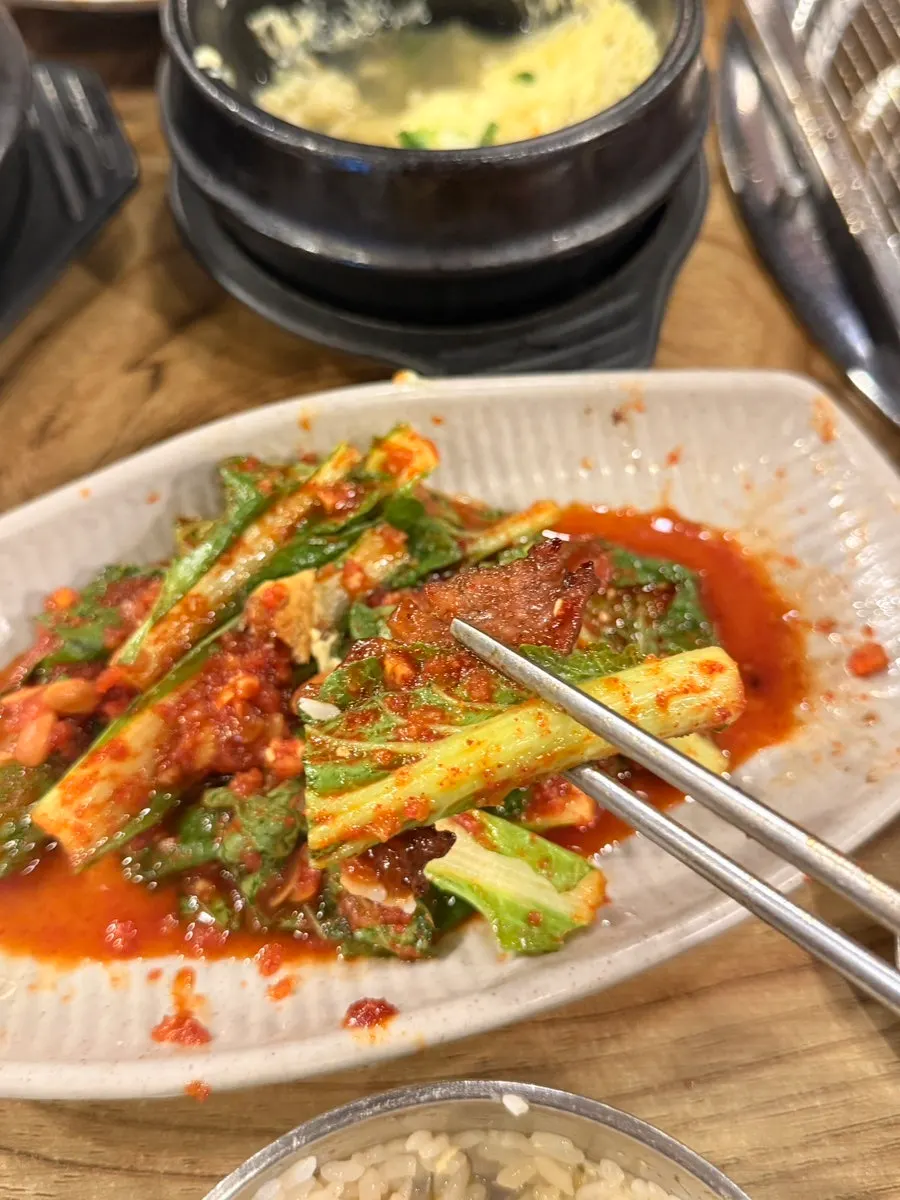 Lineup of free side dishes including steamed egg and skate stew