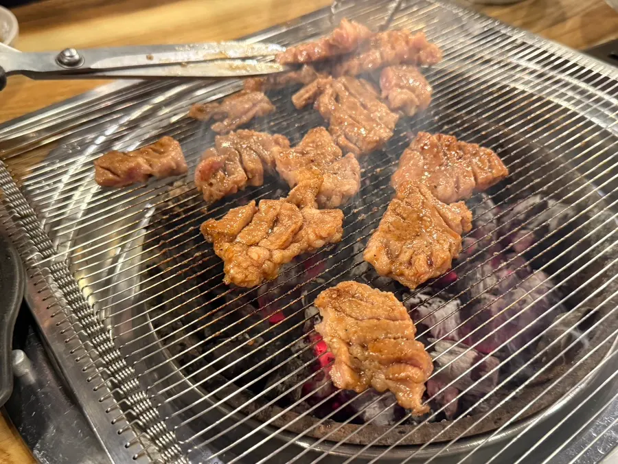 Seasoned pork galbi placed on the charcoal grill