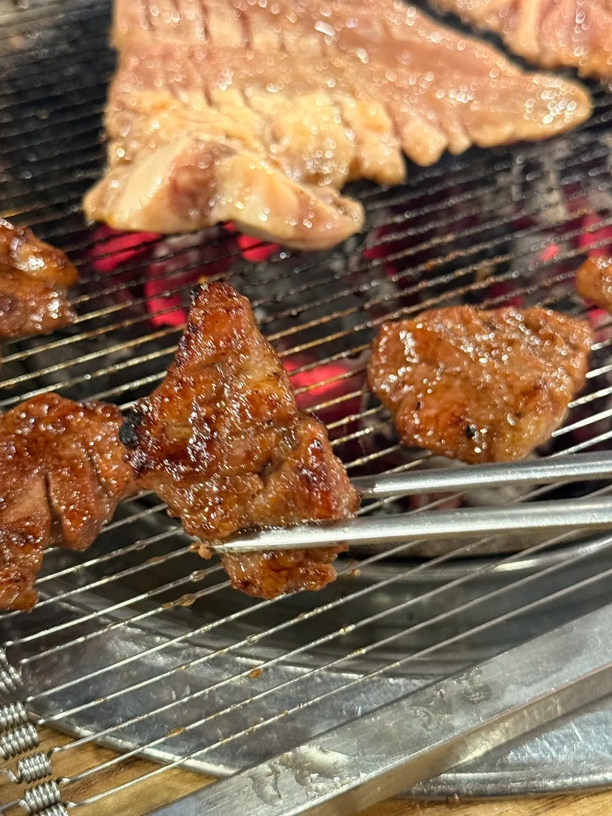Seasoned charcoal galbi grilling to a golden brown