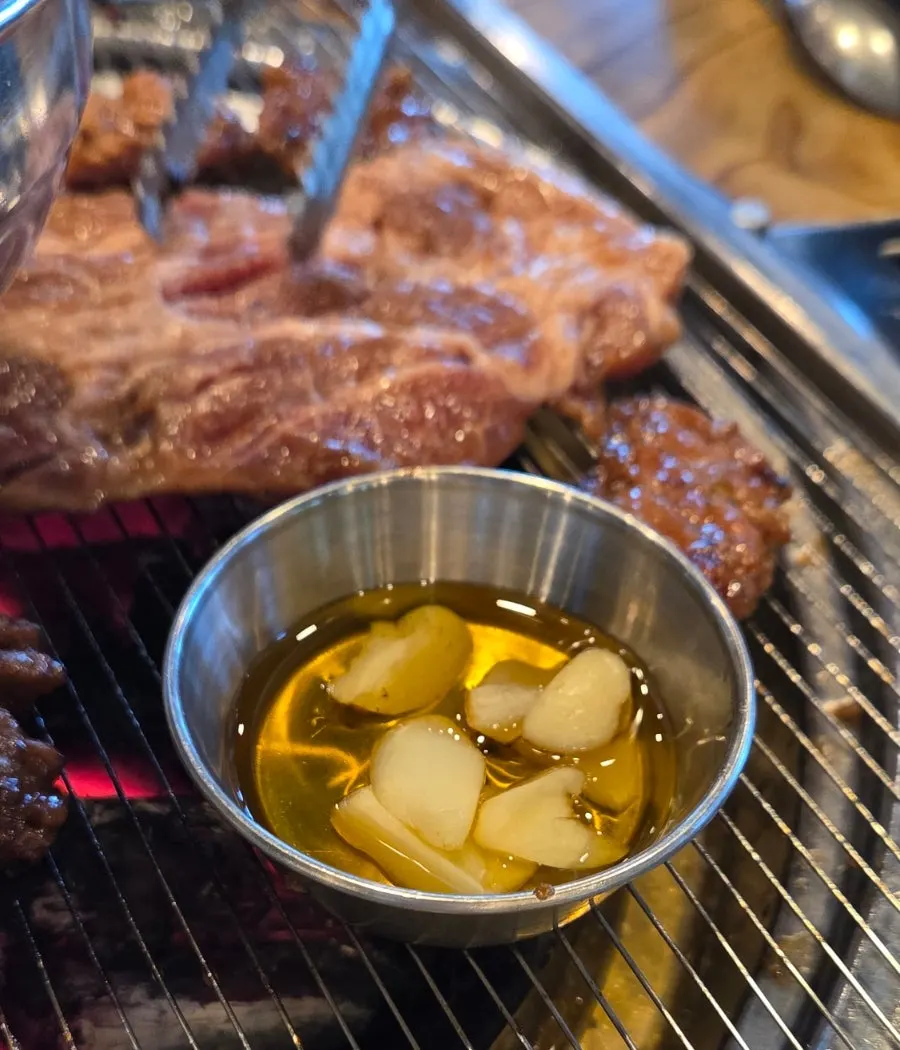 Garlic on the grill with sesame oil dipping sauce