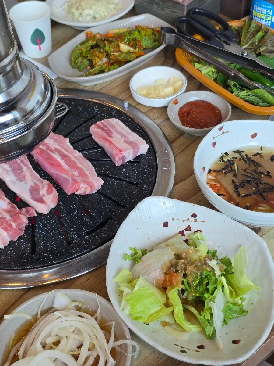 Chopsticks lifting a bite of bibim naengmyeon