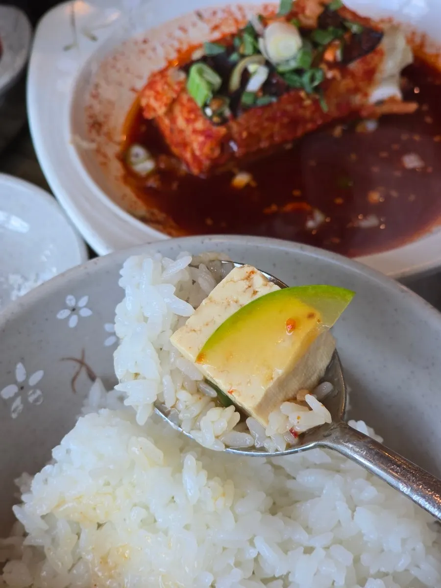 Table spread with stone pot rice and side dishes