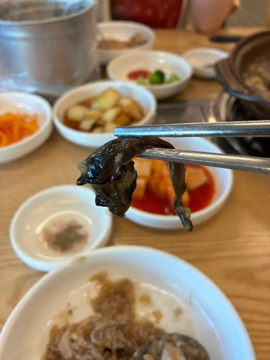 Baeksuk broth generously filled with neungi mushrooms
