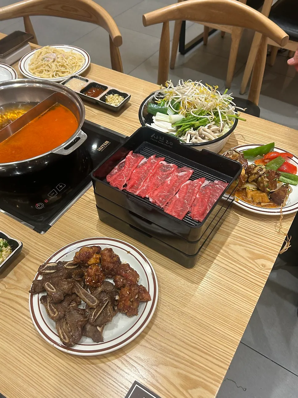 A table of shabu-shabu and buffet dishes