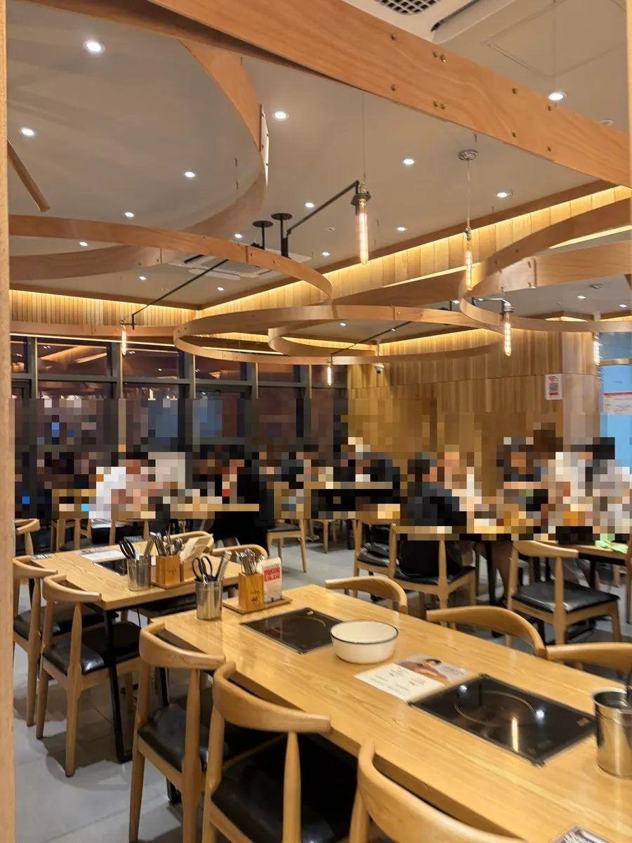 White and wood-toned shabu-shabu dining room