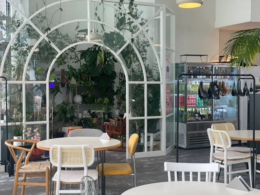 Greenhouse-like seating area at When You Bite